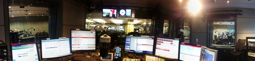 Studio showing microphones, monitors and broadcast desk.